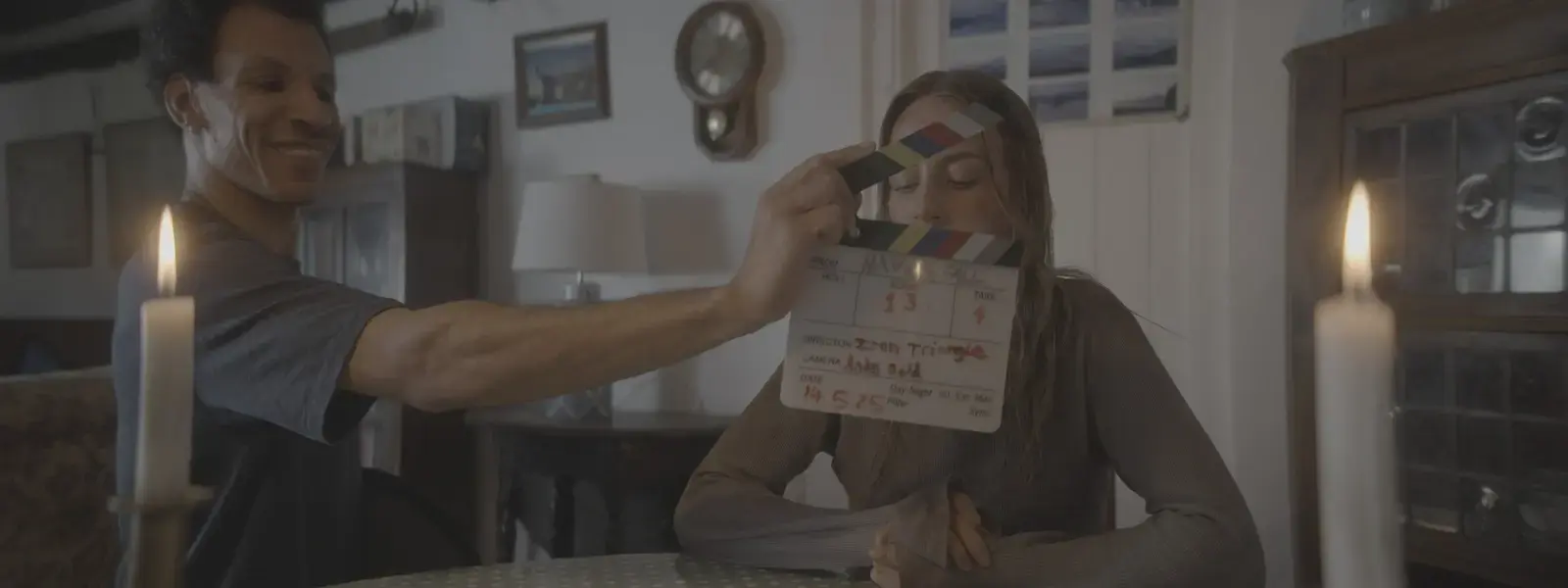 Aaron Liburd operating the clapperboard with Hannah Kirby on the Havenfall set