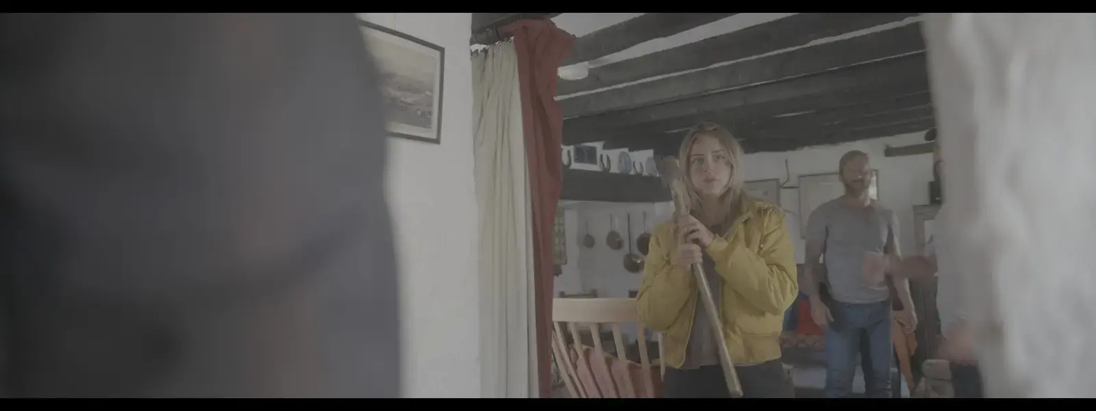 Cast and crew preparing a cottage interior scene