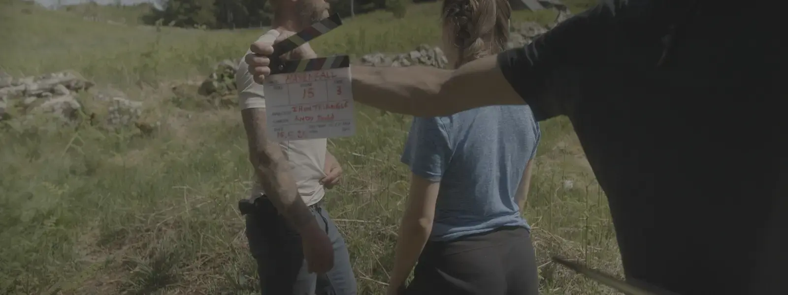 Clapperboard and cast during an exterior Havenfall setup